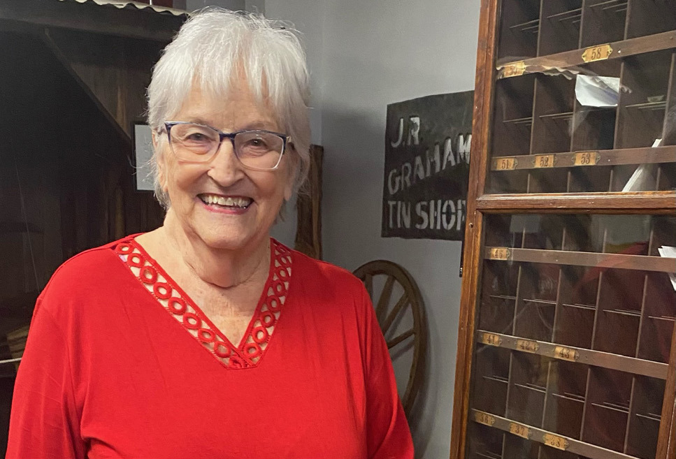 Sherry Hopson poses in front of the post office exhibit at the Coryell Museum and Historical Center. The Gatesville Messenger | David Scott