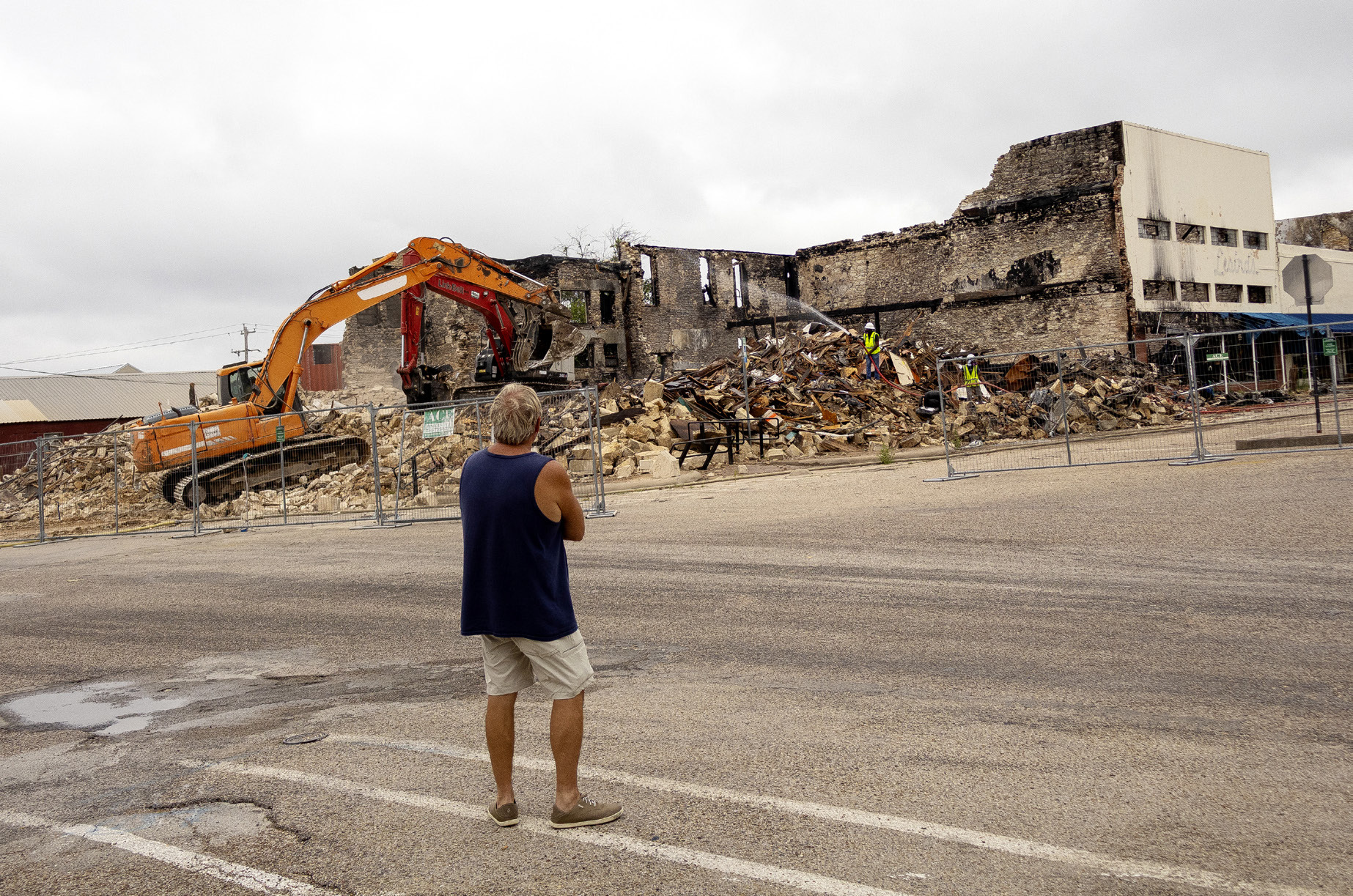 A Freedom Bail Bonds owner JW Bear watches as the demoliton continues on the downtown square where his building and office once stood. A fire on March 16, destroyed the entire block on South 6th street. CCLP/DAVID MORRIS