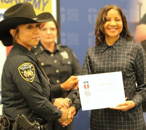 Whitney A. Myers, Gatesville Police Department, receives her graduation certificate from Central Texas College Chancellor Dr. Michele J. Carter during the Police Academy Basic Peace Officer Course Alpha Class of 2026 commencement ceremony.