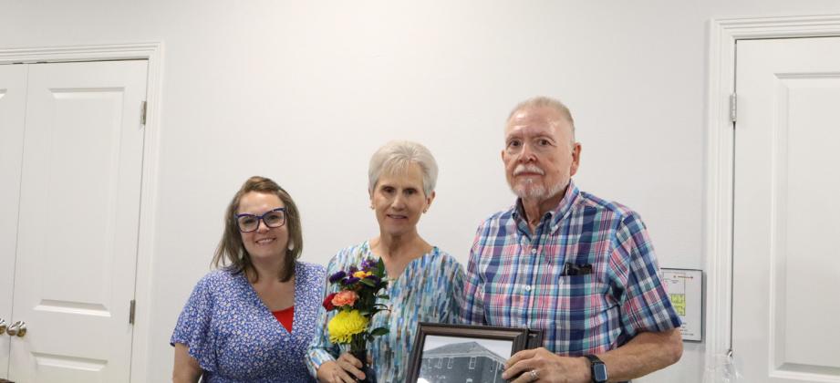 Mission Righteous Roots executive director Melanie Webb (left) poses with Annette (middle) and Bill Cole (right) after unveiling the conference room dedicated to the couple during the Volunteer Banquet on July 24. THE GATESVILLE MESSENGER/ Ally Henkil