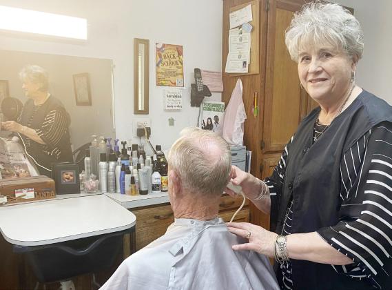 Linda Lovelace giving her favorite customer, her husband David, a trim. Gatesville Messenger/ David Scott