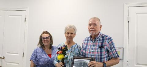 Mission Righteous Roots executive director Melanie Webb (left) poses with Annette (middle) and Bill Cole (right) after unveiling the conference room dedicated to the couple during the Volunteer Banquet on July 24. THE GATESVILLE MESSENGER/ Ally Henkil