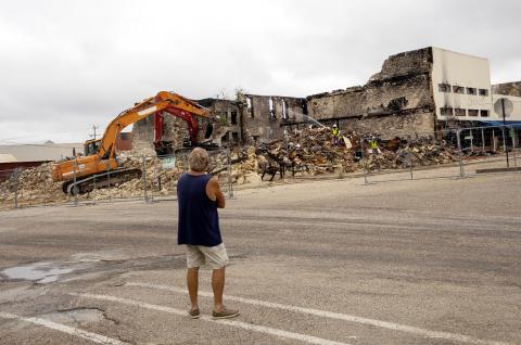 A Freedom Bail Bonds owner JW Bear watches as the demoliton continues on the downtown square where his building and office once stood. A fire on March 16, destroyed the entire block on South 6th street. CCLP/DAVID MORRIS