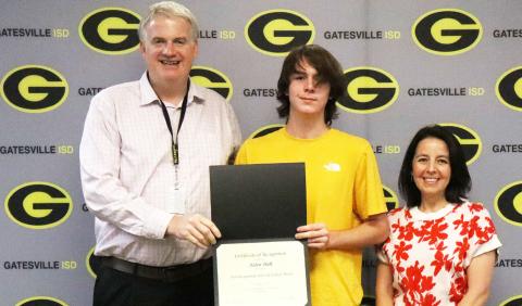 From left to right GISD Superintendent Dr. Barrett Pollard, GHS senior Aiden Holt and GHS principal Liz Shoaf pose as Holt is recognized during the Student Spotlight portion of the Sept. 21 school board meeting. Gatesville Messenger | Ally Hinkle