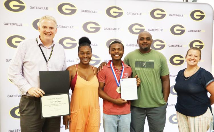 GISD Superintendent Barrett Pollard (far left) and Choral Director Cherith Wells (far right) pose with Nevin Benning (middle) and his family during the Student Spotlight portion of the Monday, June 22, School Board meeting. Gatesville Messenger/Ally Hinkle