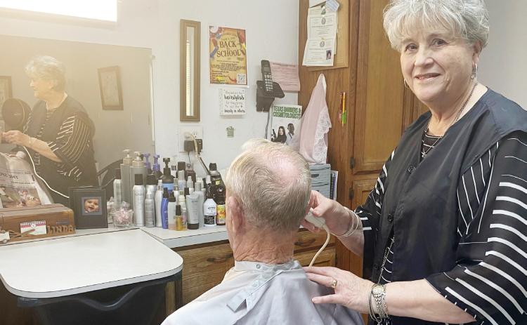 Linda Lovelace giving her favorite customer, her husband David, a trim. Gatesville Messenger/ David Scott