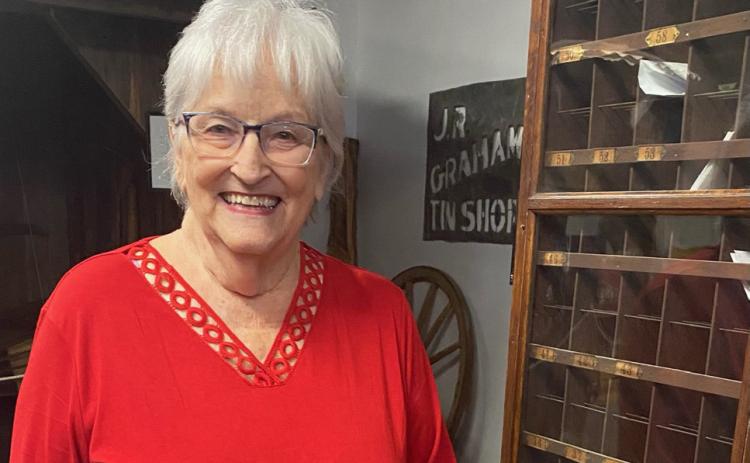 Sherry Hopson poses in front of the post office exhibit at the Coryell Museum and Historical Center. The Gatesville Messenger | David Scott