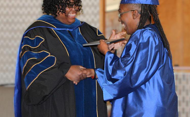 CTC Vice Chancellor of Instruction and Workforce Education Tamara Clunis presents an Associate of Arts degree to Jeremisha Adams at the April commencement ceremony. The college is expanding course offerings to enroll more students thanks to a $750,000 grant from the Trellis Foundation. COURTESY PHOTO