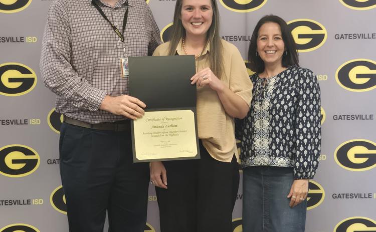 From left to right: GISD Superintendent Dr. Barrett Pollard, staff member Amanda Latham and high school principal Liz Shoaf pose during the Staff Spotlight portion of the Monday, Aug. 17, school board meeting. Ally Hinkle I The Gatesville Messenger